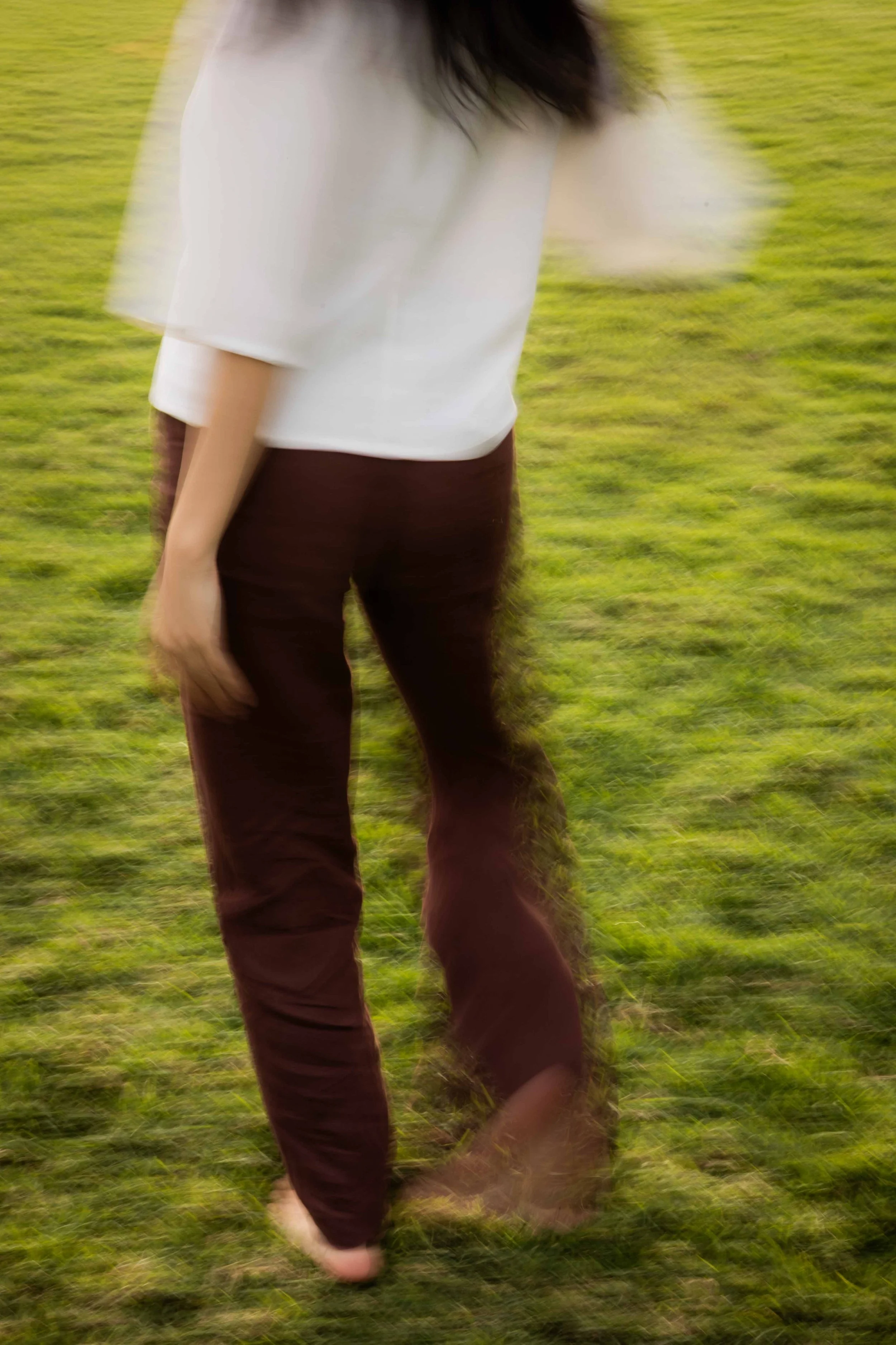 Olivia Lei walking in motion, captured from behind.