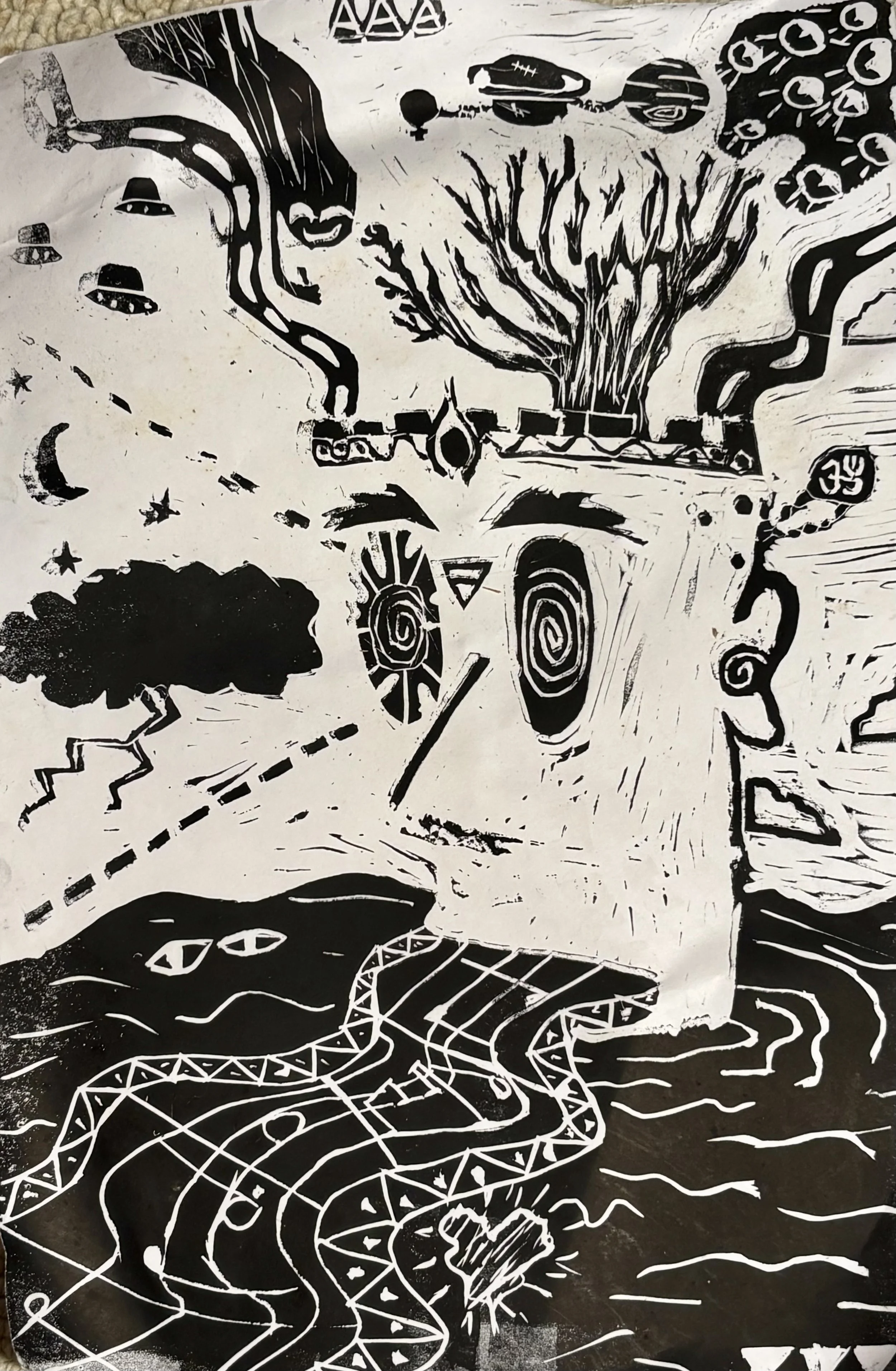 Black and white abstract block print featuring a head with a tree growing out of with radiating branches, various geometric shapes, pathways, animals such as a snake, a bird, and an alligator, as well as symbols like eyes, lightning bolts, and stars.