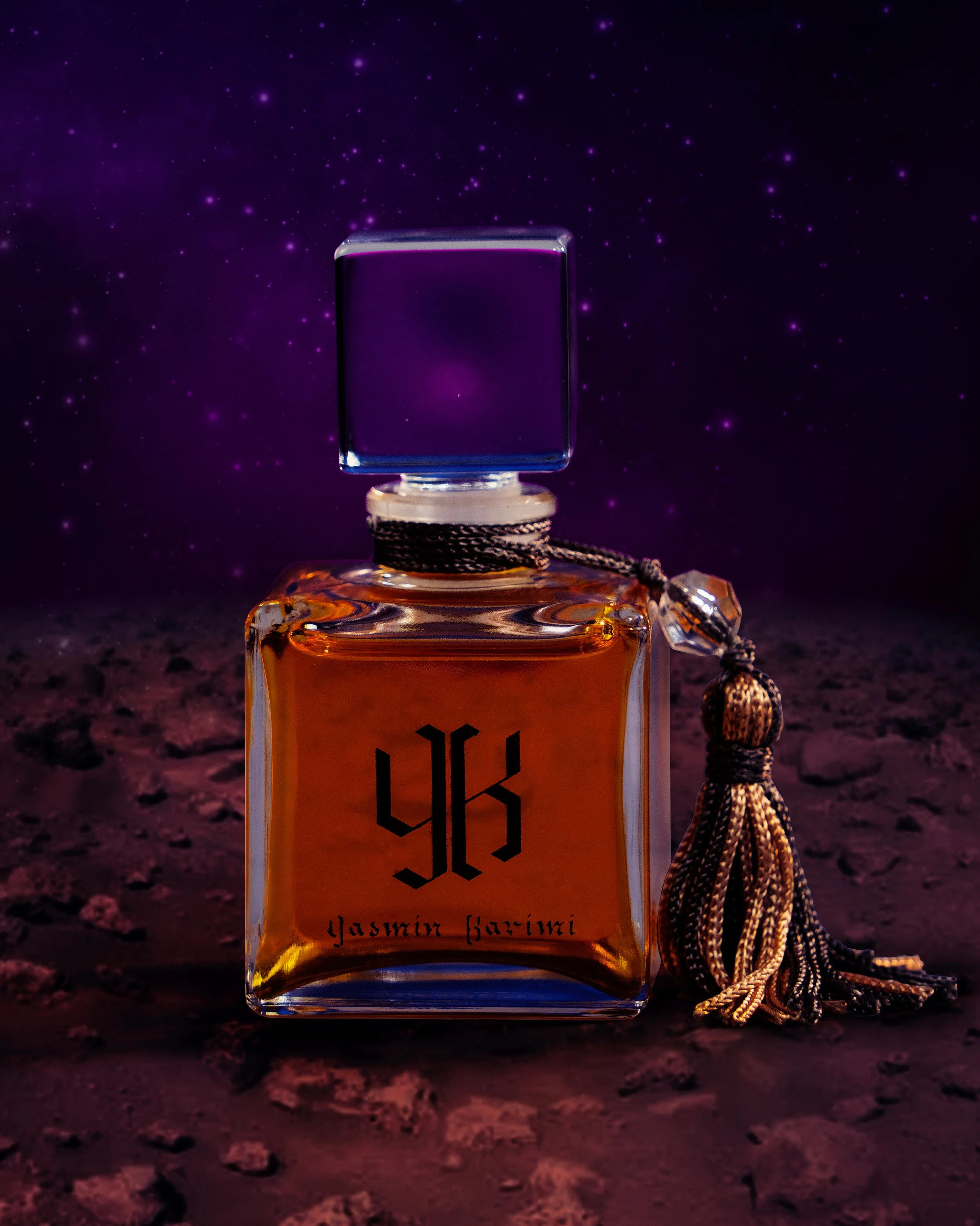 A perfume bottle labeled 'Yasmin Fierce' by YSL, set against a cosmic background with stars and a rocky terrain.