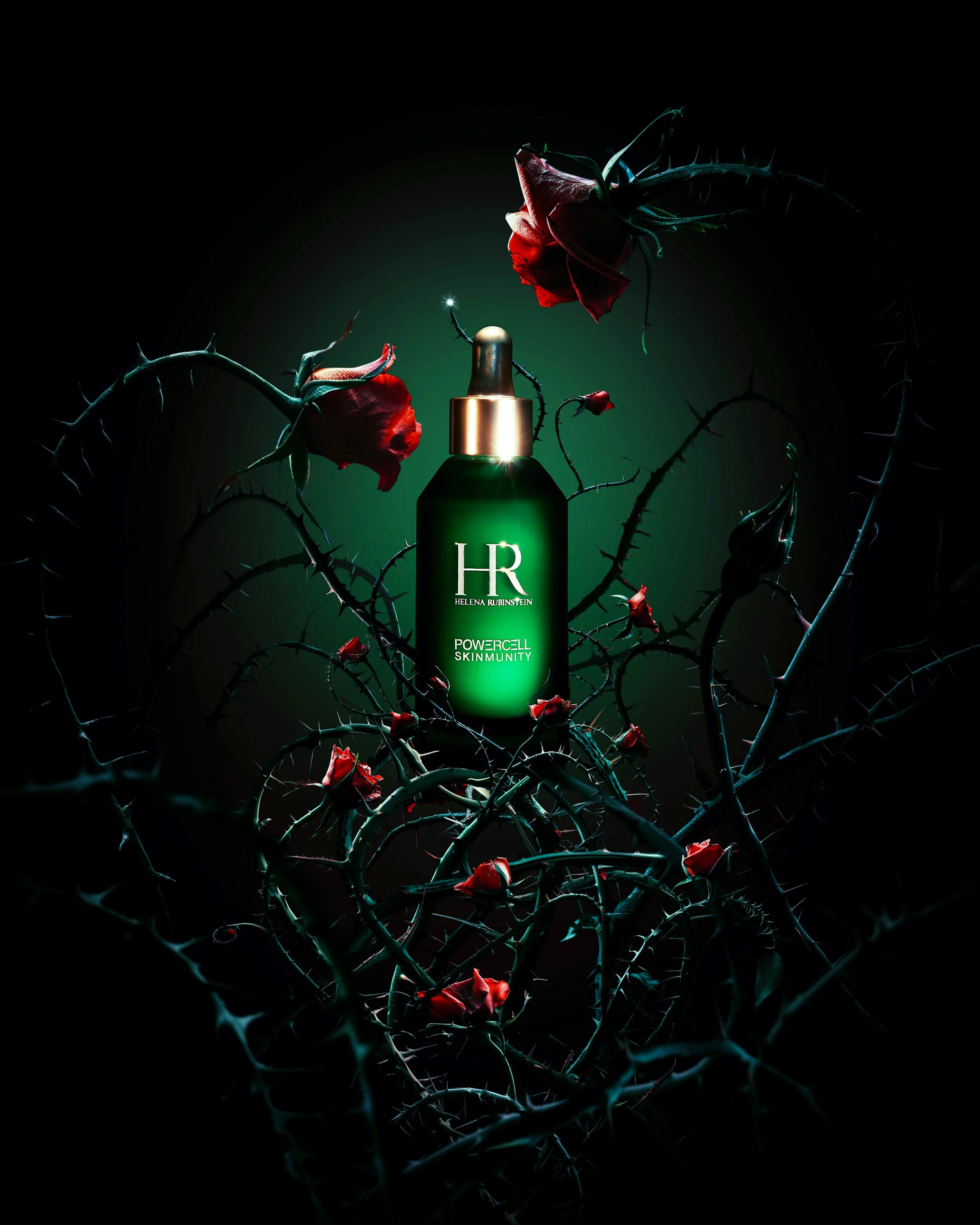 A dark background with a green treatment serum bottle labeled 'HR Helena Rubinstein Powercell Skinmunity' in the center. The bottle is surrounded by thorny rose branches with red rosebuds and flowers, some of which are illuminated, creating a dramatic contrast with the black backdrop.