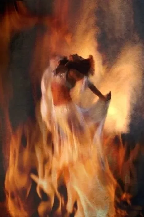Woman emerging from fire — The Sacred Descent women's transformational retreat, Marbella 2026