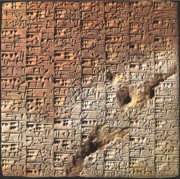 Ancient clay tablet covered in cuneiform script, with a large missing section and damage.