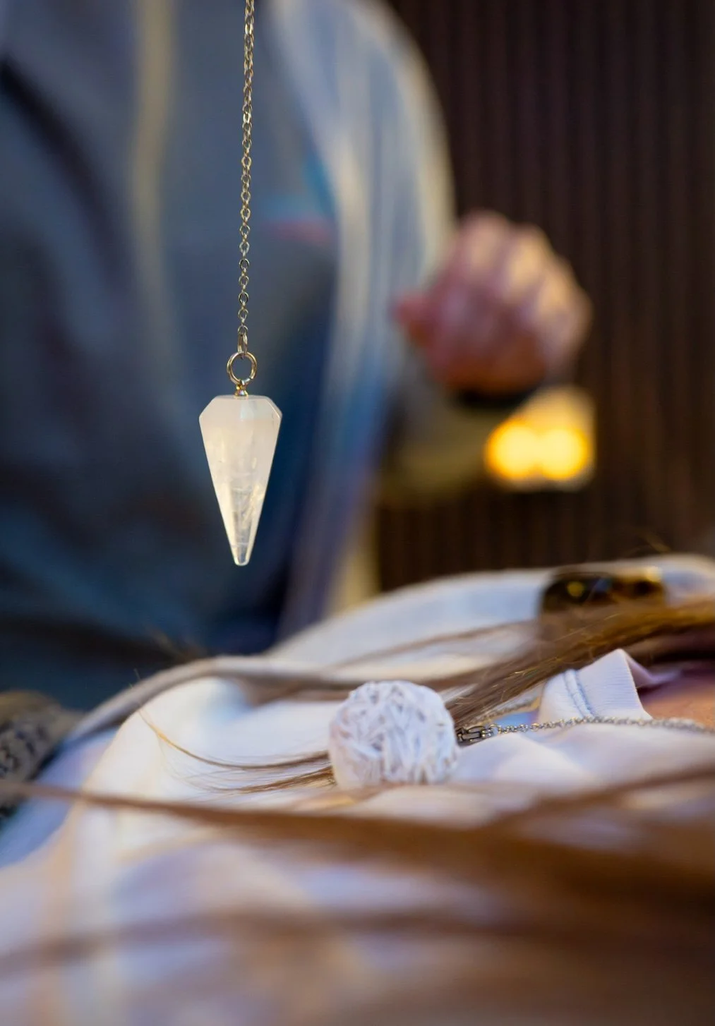 Client receiving crystal healing treatment during a holistic therapy session in a calm, soothing environment