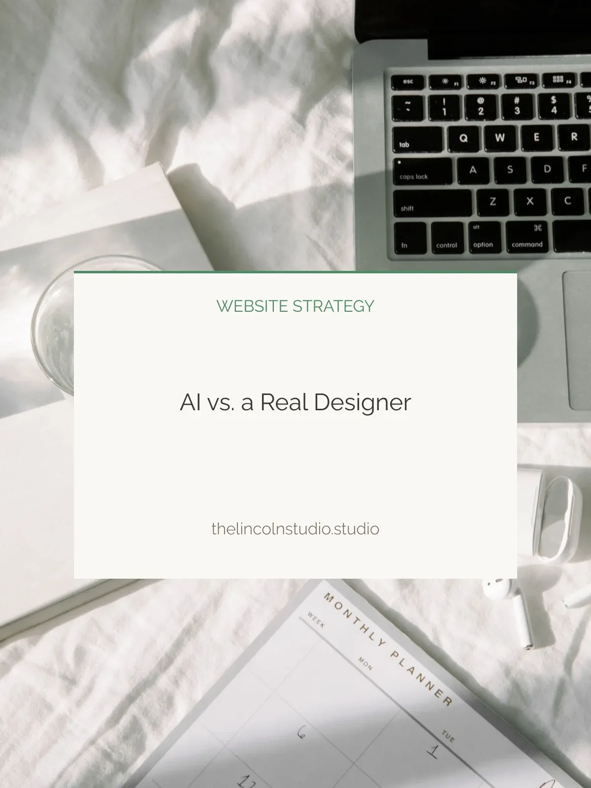 Flat lay of a workspace with a laptop, a glass of water, a planner, and a presentation slide titled 'Website Strategy: AI vs. a Real Designer' from thelincolnstudio.studio.
