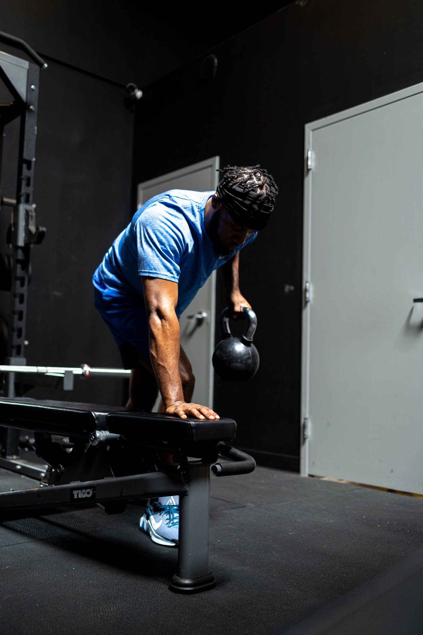 Man doing workout with kettlebell in gym