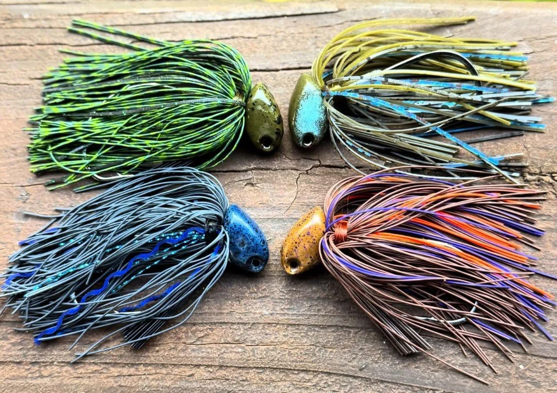 Fishing jigs in multiple colore laid out on wooden plank