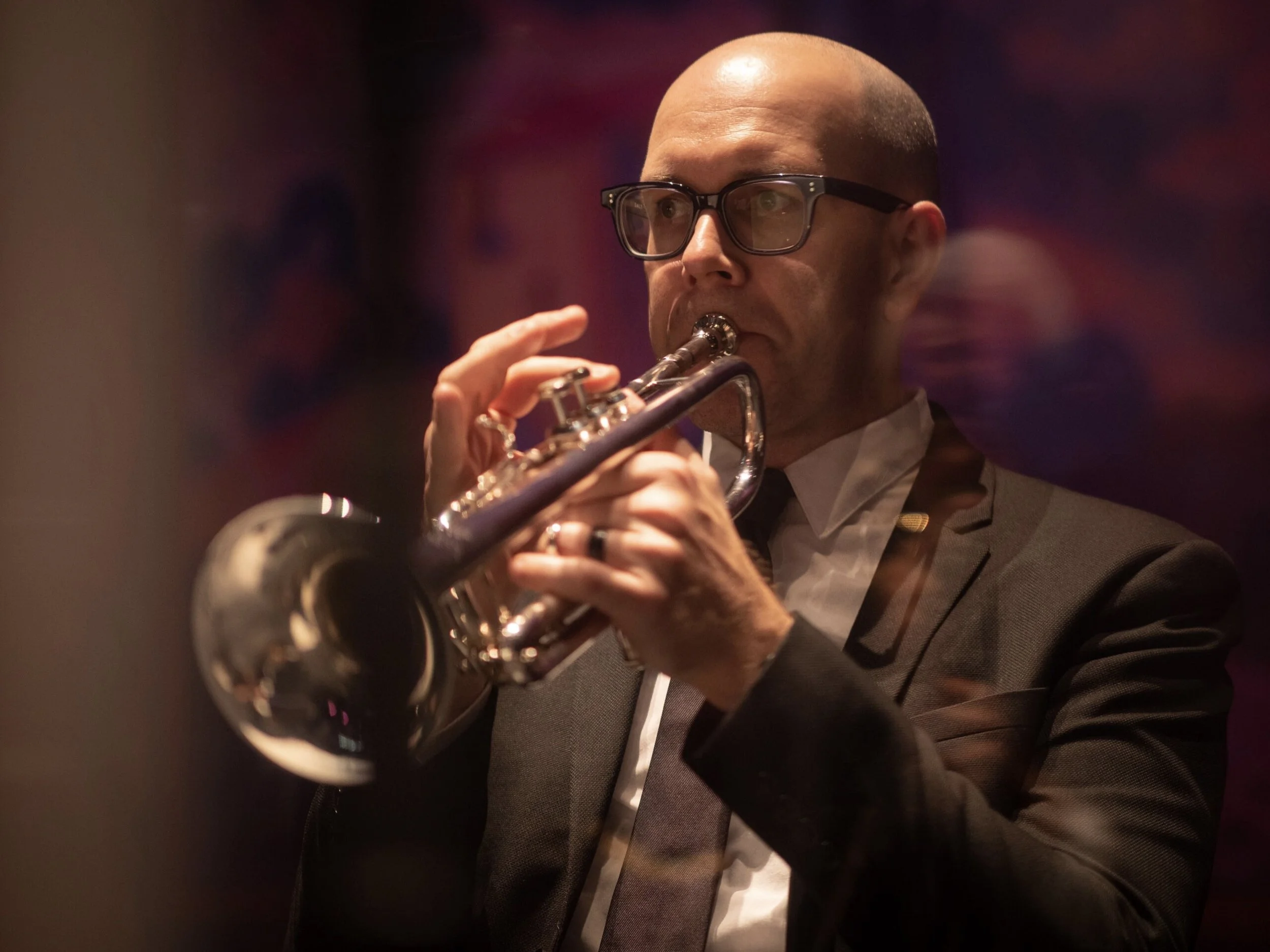 Man playing the trumpet on a stage.
