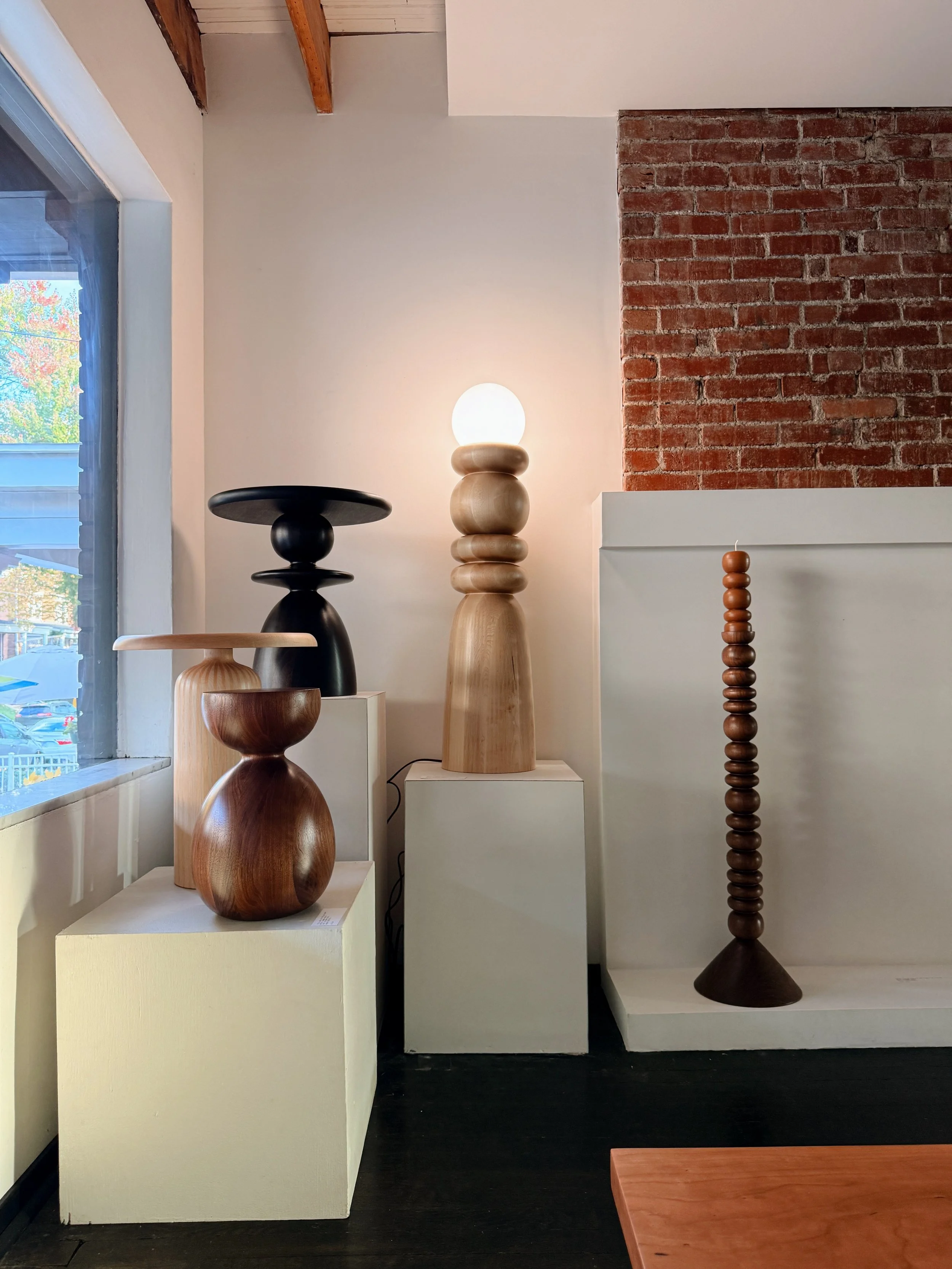 Hand-turned maple table lamp with hand-applied white striping by Hanna Dausch of Han Studio, featured in Mono’s Playing House exhibition.