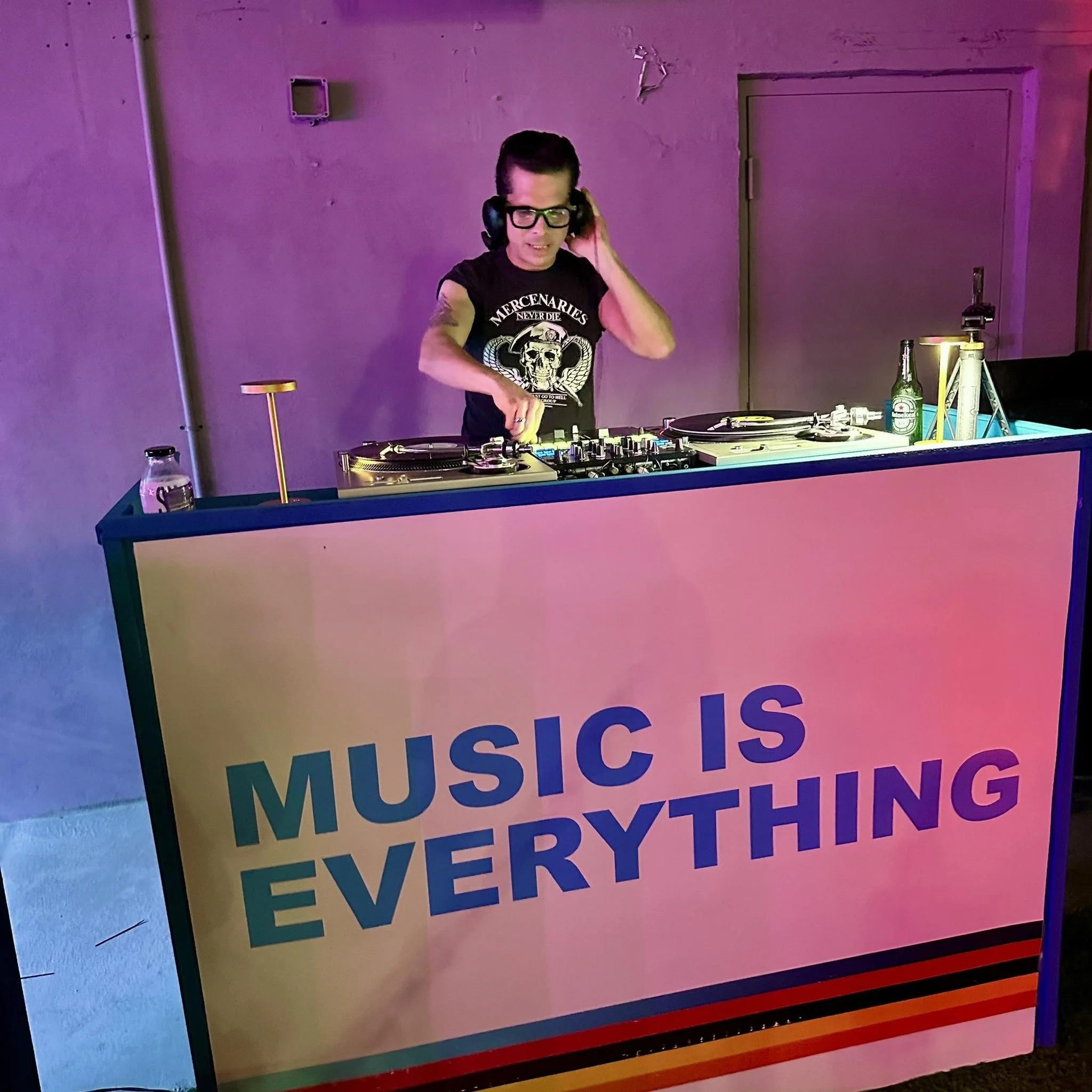 Colorful poster with the words "Music is the universal language" and rainbow-colored stripes at the bottom.