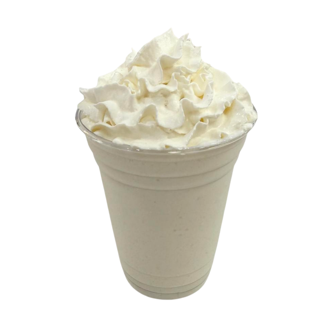 A tall clear plastic cup filled with vanilla milkshake topped with whipped cream.