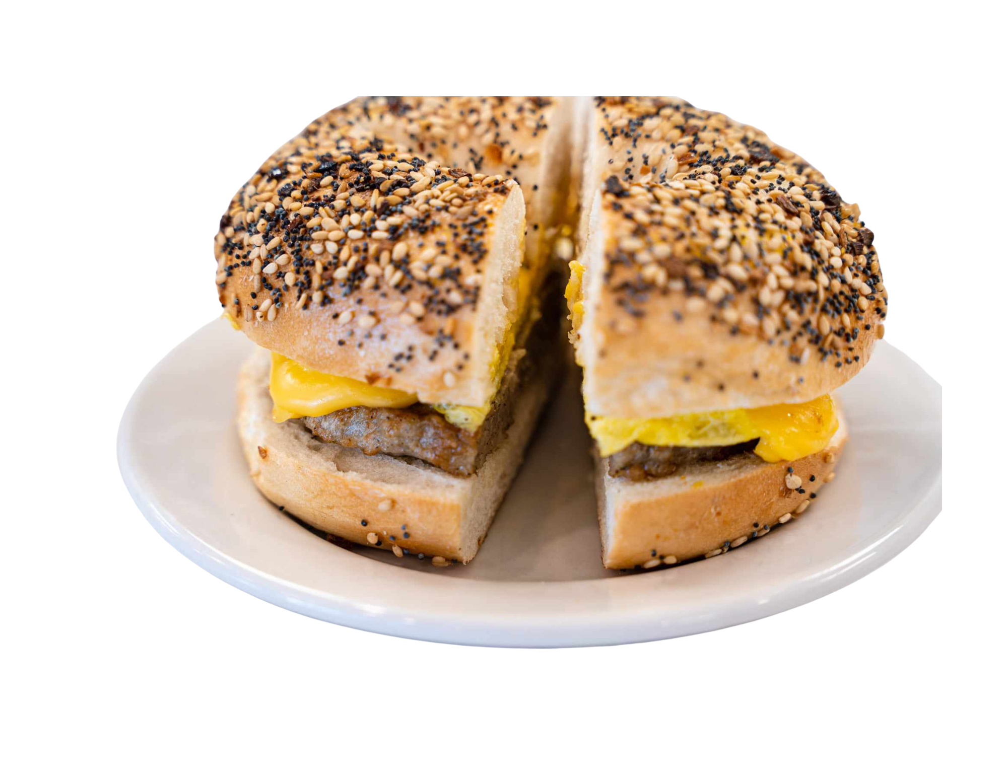 A close-up of a sandwich with cheese, beef patty, and sesame seed bagel on a white plate.