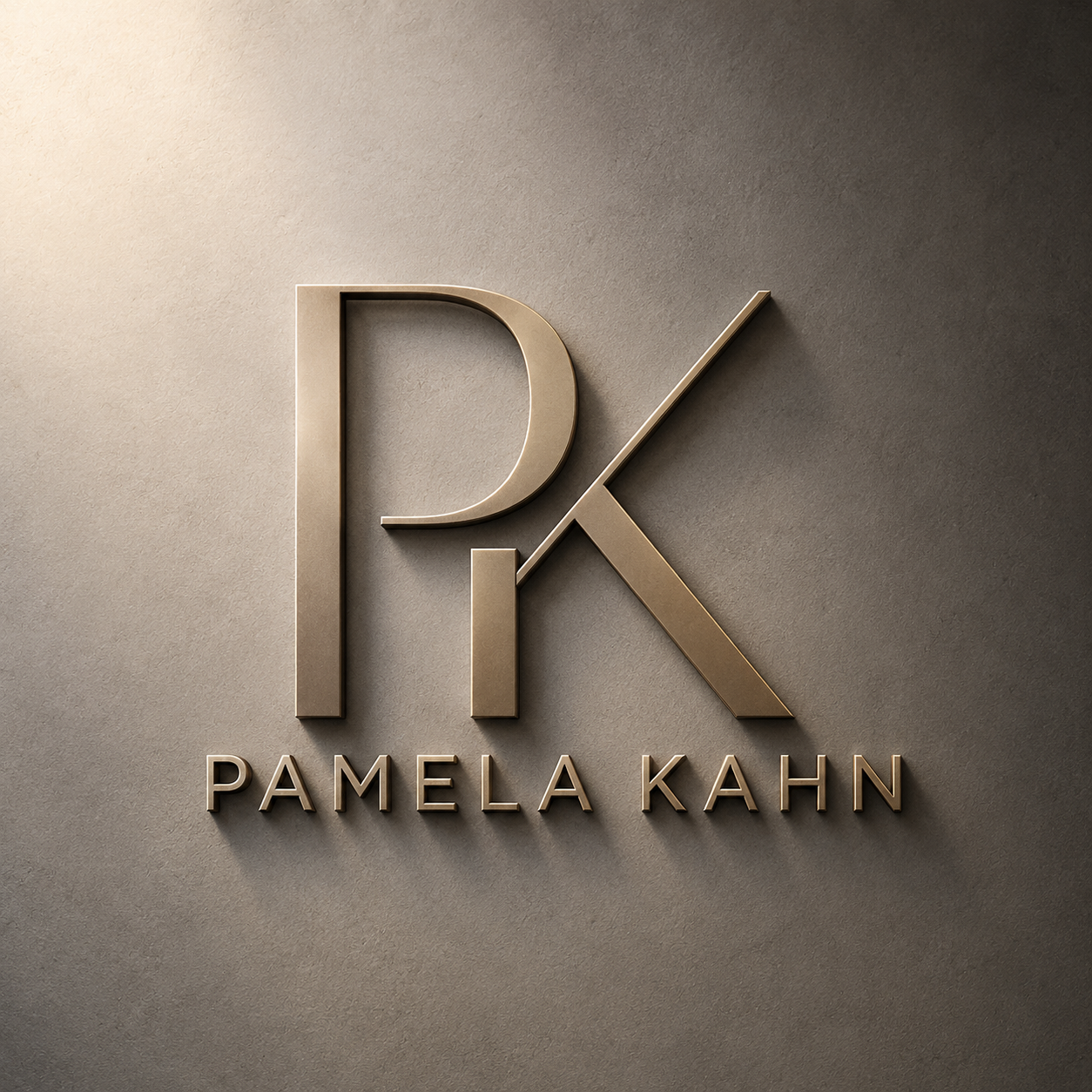Metal logo of the initials 'PK' with the name 'Pamela Kahn' below, mounted on a textured beige wall.