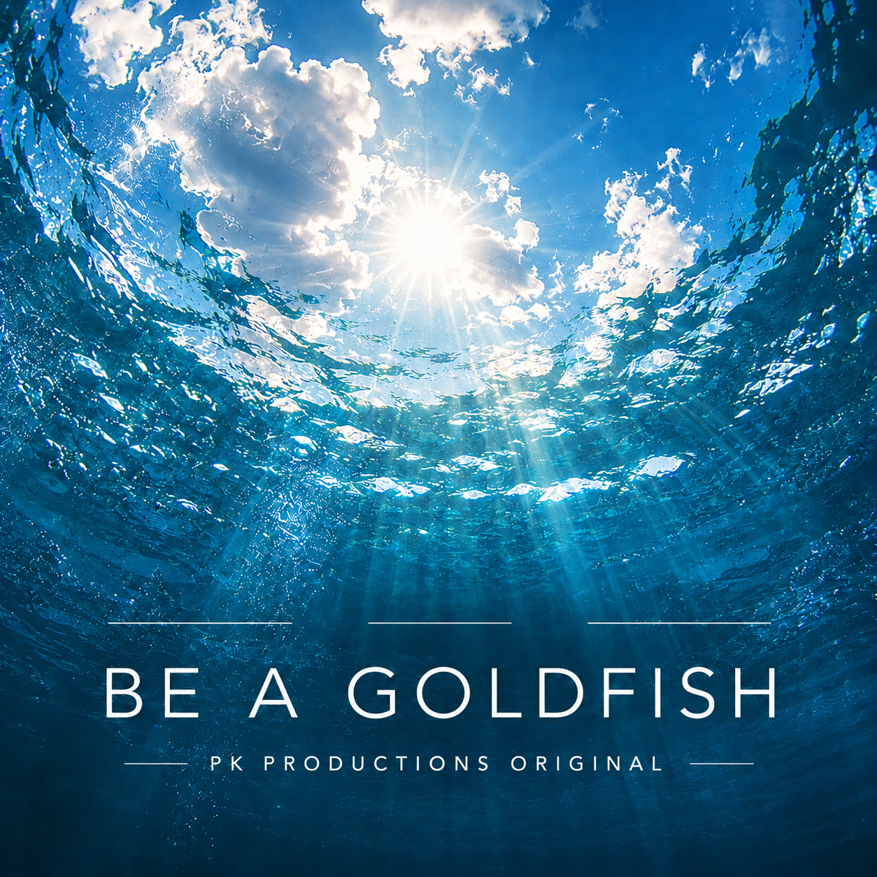 Underwater view looking up with sunlight shining through the water's surface, creating rays of light and blue hues. Text says "Be a Goldfish, PK Productions Original."