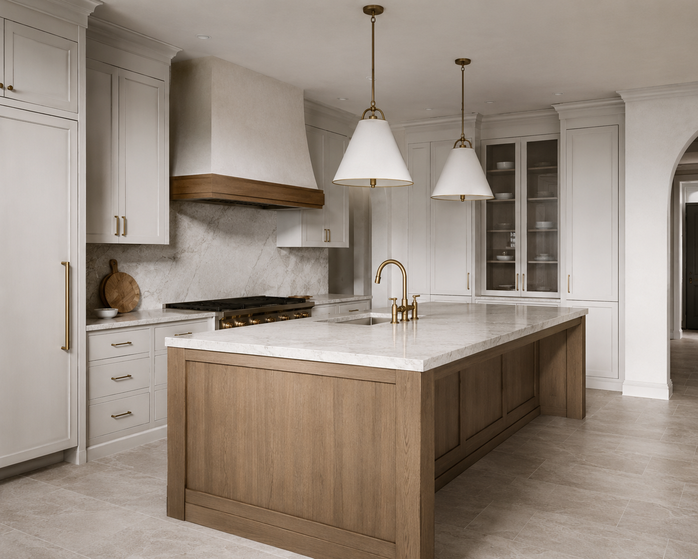 Modern kitchen with white cabinets, marble countertops, wooden island with brass fixtures, and hanging pendant lights.