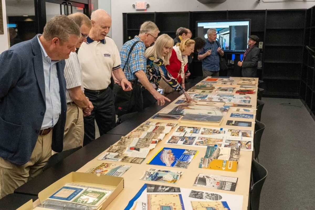 PONY Branch members examining a curated sample of the museum’s extensive collection of ocean liner and cruise ship memorabilia that was put on display for our visit.