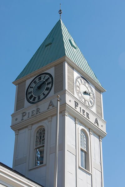 The Pier A clock tower with a ship’s clock installed in 1919 for WWI memorialization.
