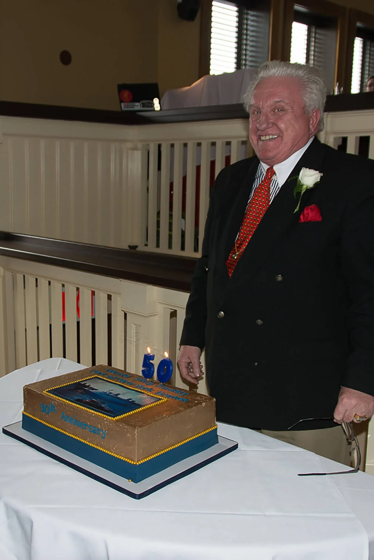 Bill Miller, “Mr. Ocean Liner” and a founding PONY Branch blows out the candles.