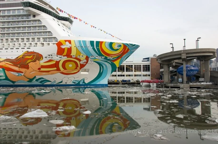 Several of the ship’s tenders can be seen tied up at the pier.