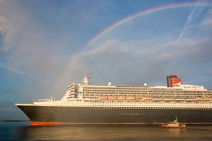 QUEEN MARY 2 framed in a rainbow from the spray of the fireboat JOHN J. HARVEY.