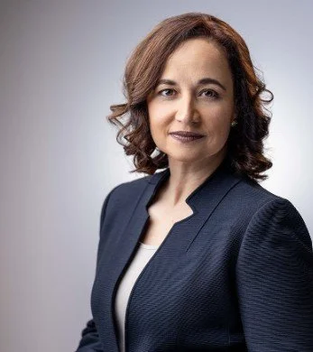 A professional photo of Jennifer N. Stelletti posing against a plain gray background.