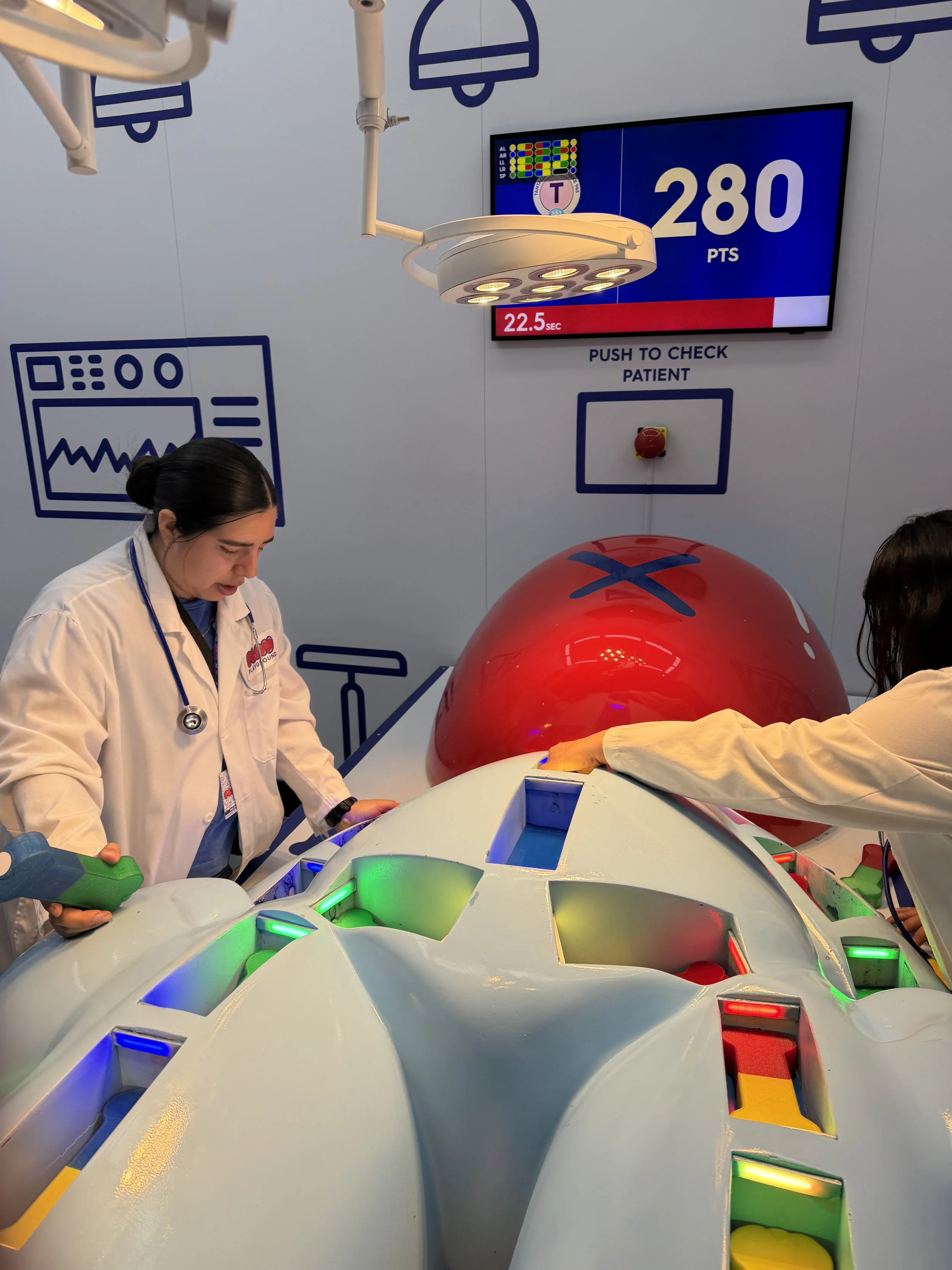 Medical staff in white coats working on a futuristic medical device with colorful lights, in a high-tech medical setting with digital displays and medical icons.