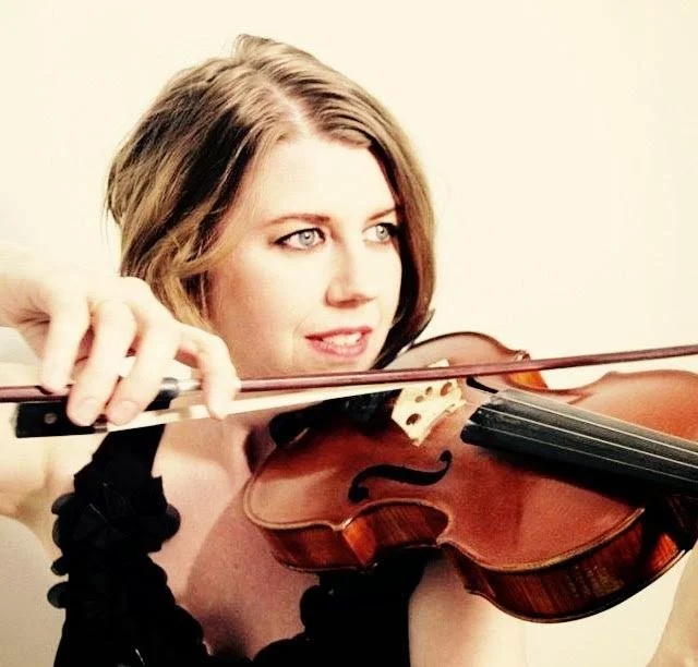 Professional violinist Jaime Smith  playing the violin in front of the camera.