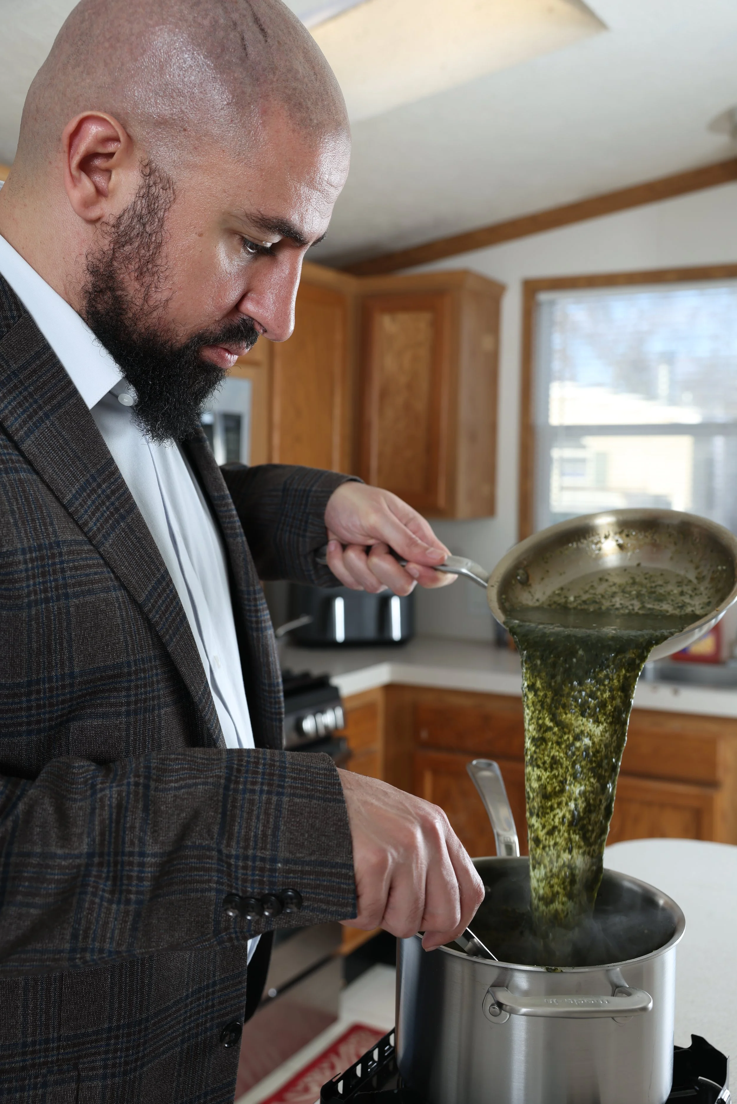 The Egyptian Cook pouring Egyptian molokhia