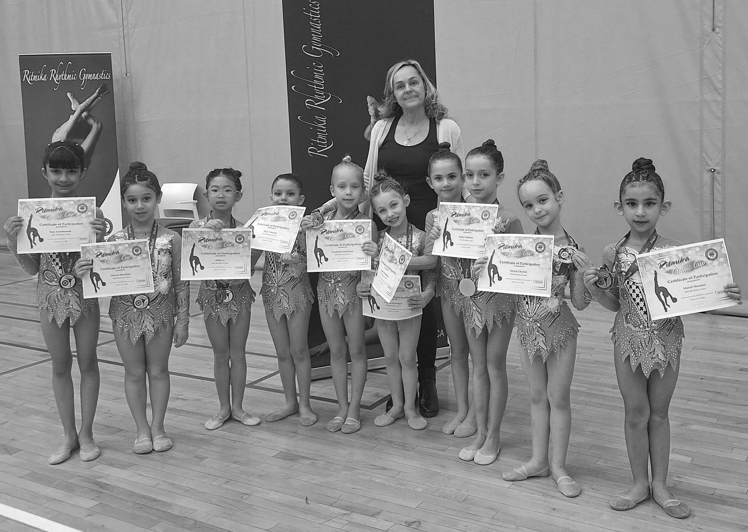 Interclub rhythmic gymnasts celebrating competition success with their awards at the Markham Pan Am Centre.