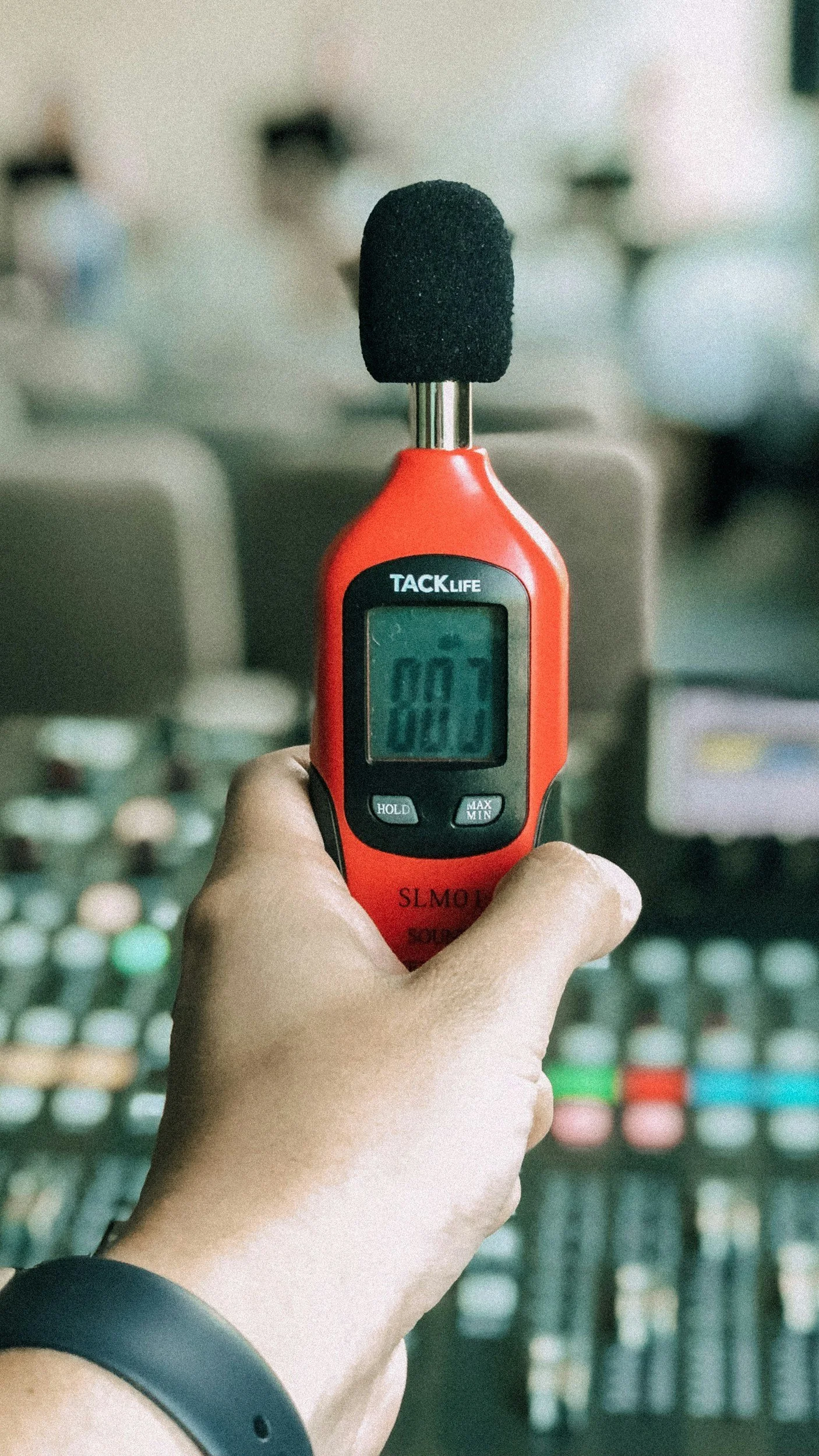 Industrial hygienist using a digital sound level meter for workplace noise monitoring