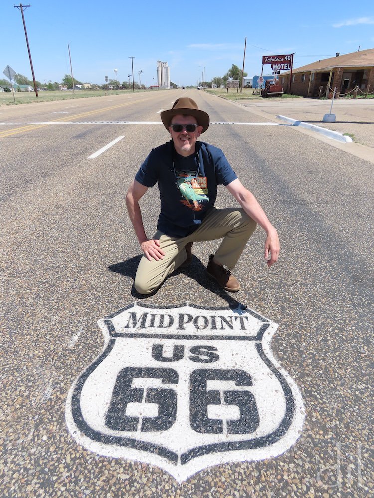 Thankfully, the midpoint sign and pavement marking shield lie on a quiet stretch of Route 66, as drivers regularly stop to pose for photos in the middle of the road.