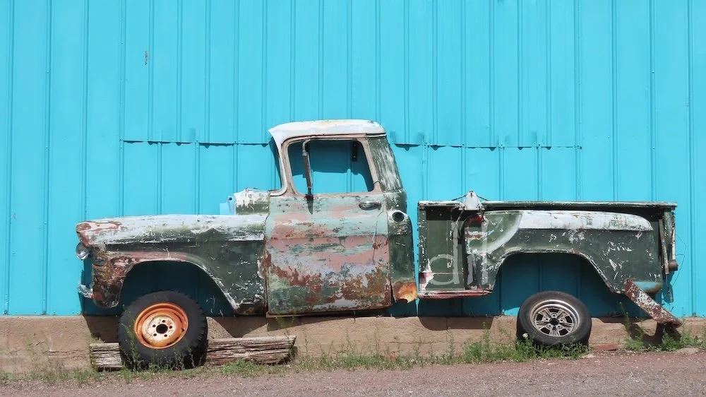 The Snow Cap property is a riot of schticky signs, vintage cars and neon, and that fun-loving style has spread throughout town. Across the street you'll find this slice of a vintage pickup welded to the side of the Road Relics antique shop. Other dis