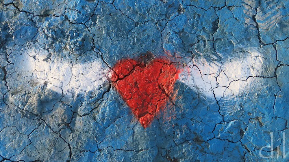 This winged heart, an enduring symbol of transcendent love, apparently took flight from the Cadillacs to light on the ground.