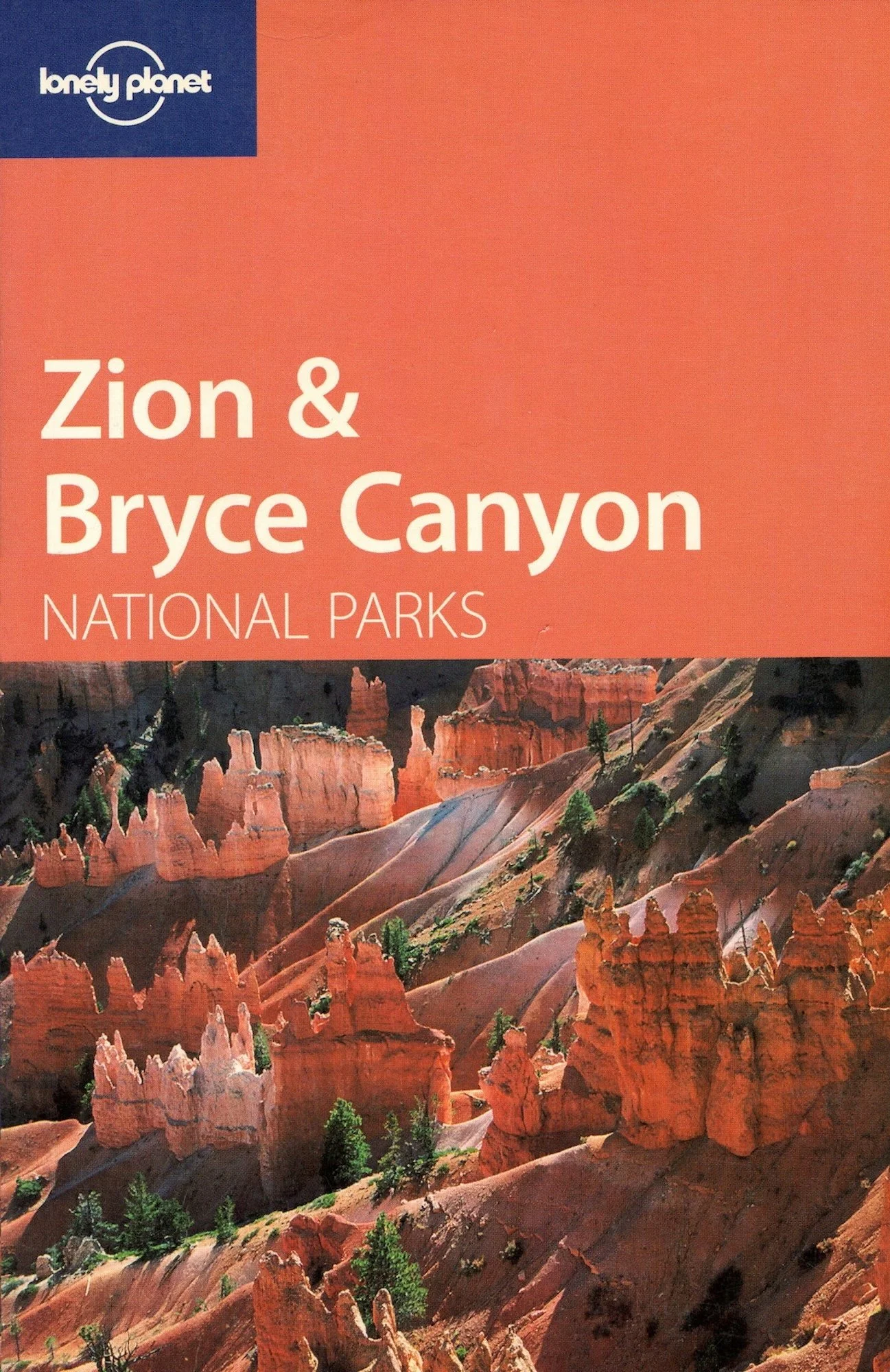 Brochure cover of Lonely Planet's Zion and Bryce Canyon National Parks featuring a landscape photograph of Bryce Canyon with tall orange and red rock formations and green trees.