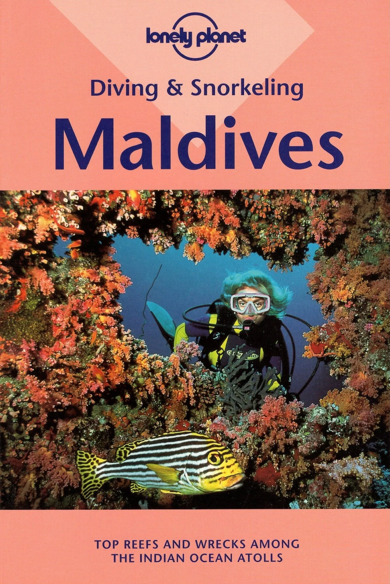 Lonely Planet's diving & snorkeling guide to the Maldives. A diver exploring a vibrant coral reef surrounded by various colorful fish, and mentioning top reefs and wrecks among the Indian Ocean atolls.