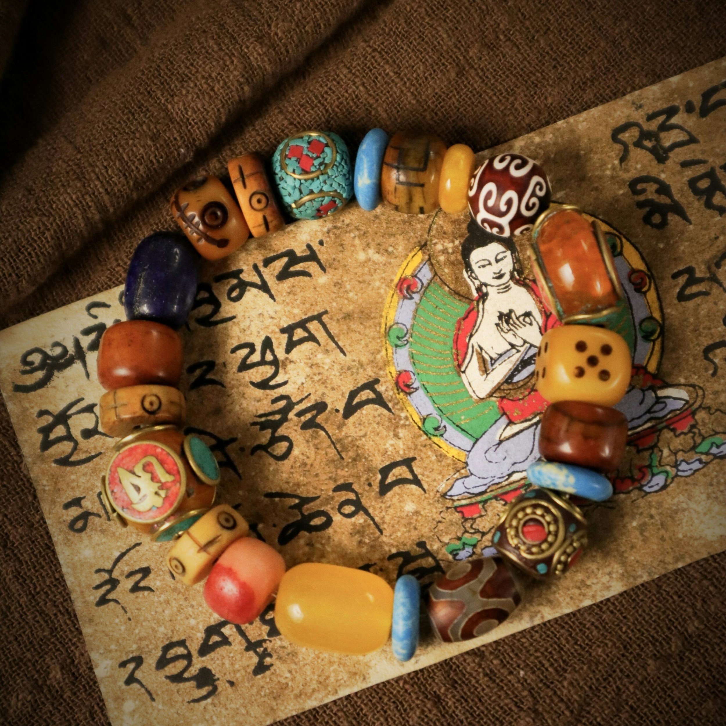 Colorful assorted beads laid on a piece of paper with handwritten text and illustrations.