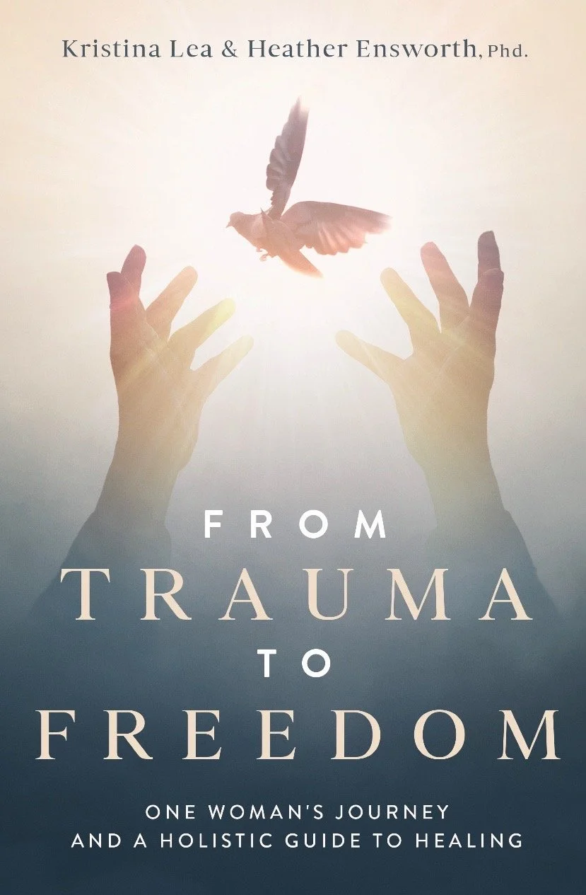 Book cover titled "From Trauma to Freedom" by Kristina Lea and Heather Ensworth. Features a pair of hands reaching toward a butterfly in flight, with a light background.