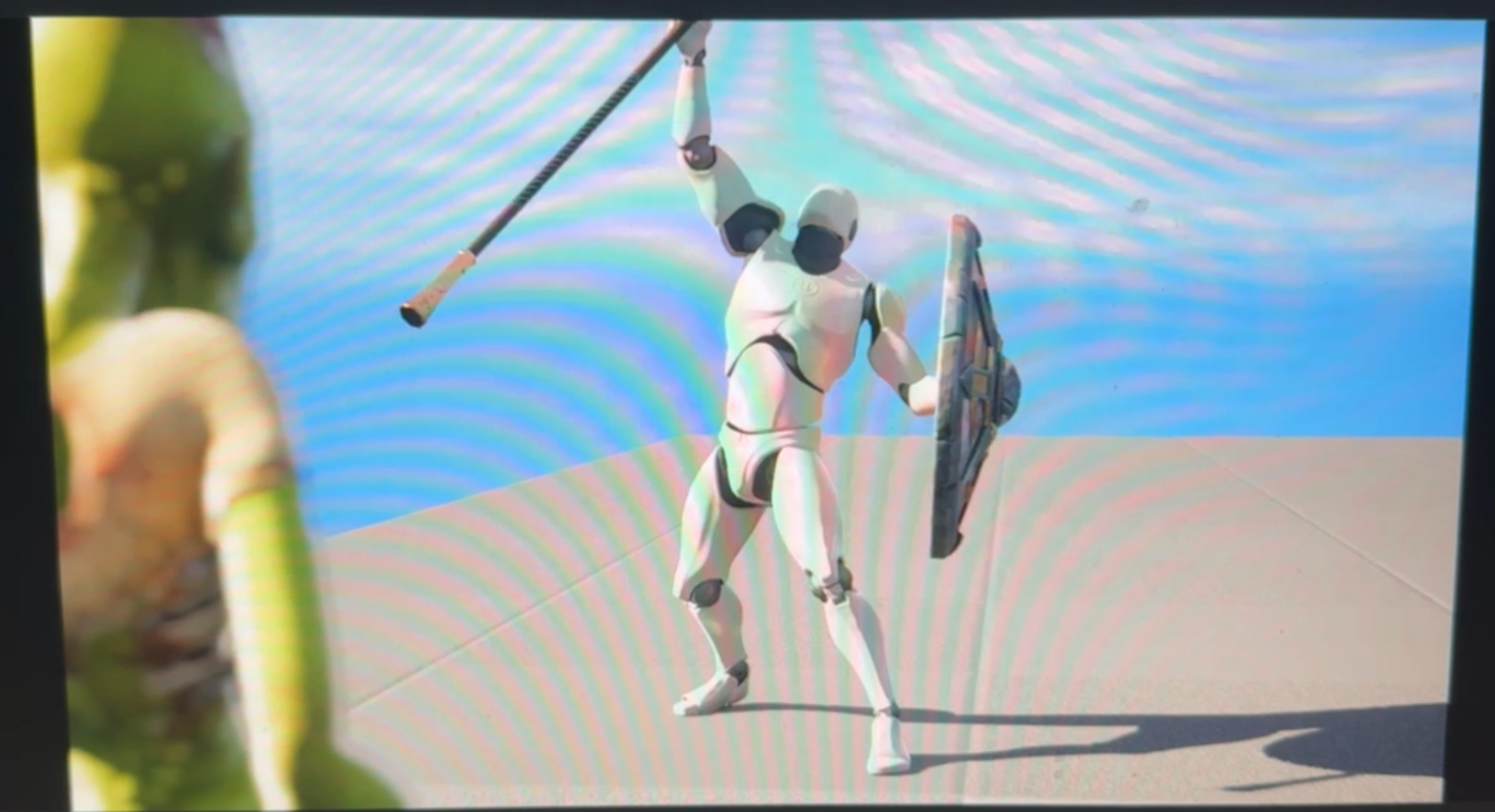 An animated robot knight holds a shield and a spear, standing on a flat surface with a blue background.