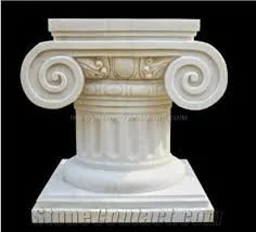 Close-up of a white Roman-style Ionic column capital with scrolls and fluted details against a black background.