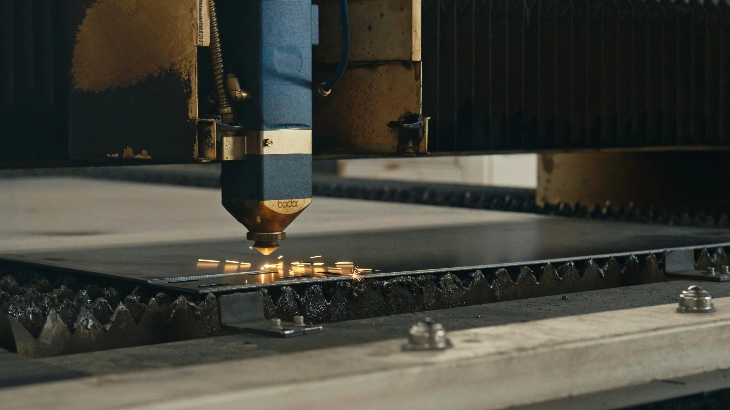 A CNC plasma cutting machine cutting through metal, producing bright sparks.