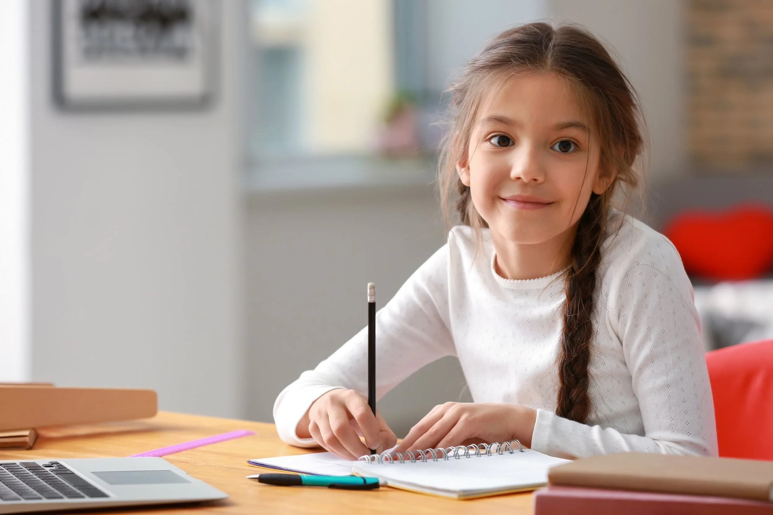 A young student focused on her schoolwork
