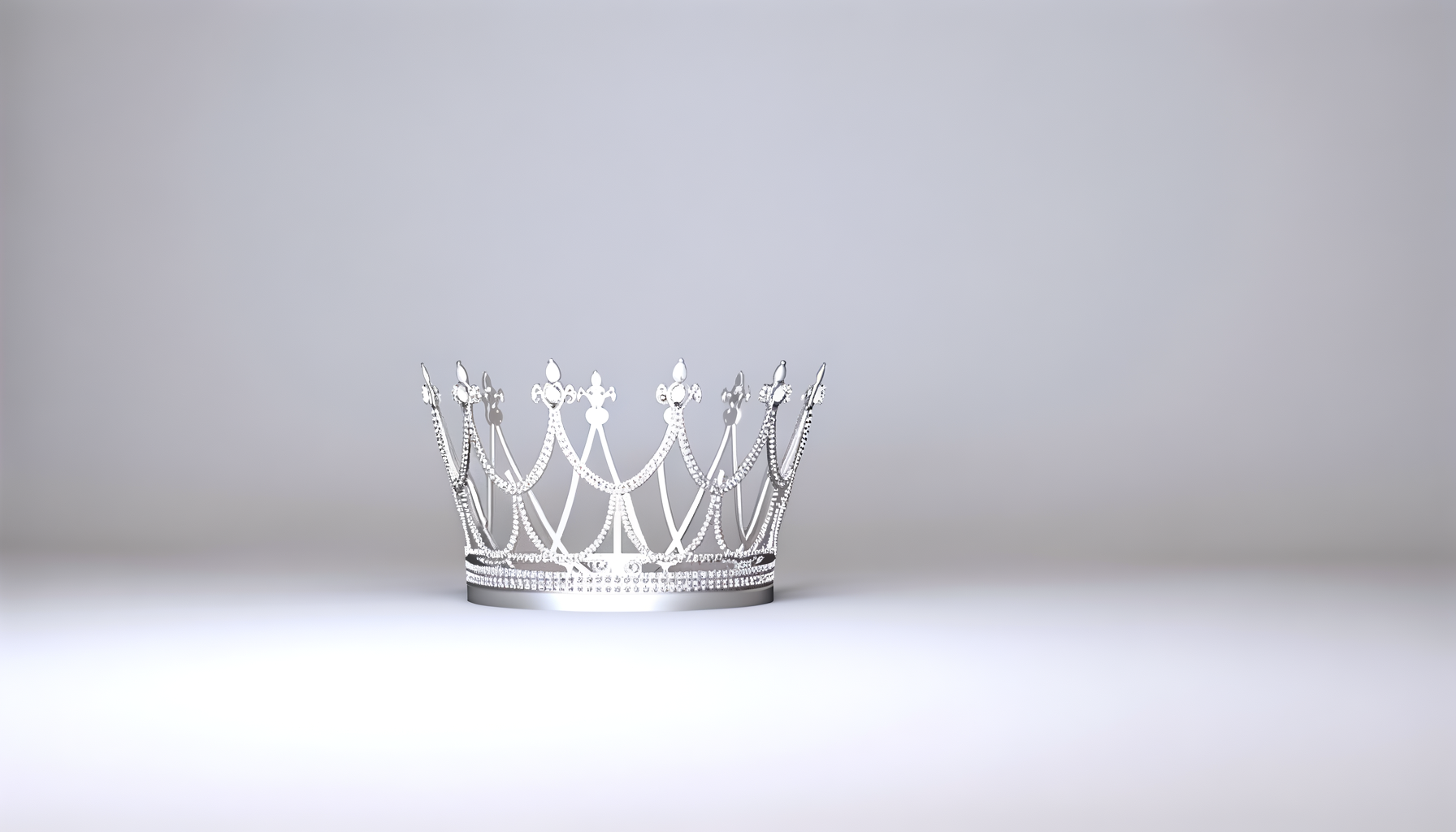A silver tiara adorned with numerous small diamonds against a light gray background.