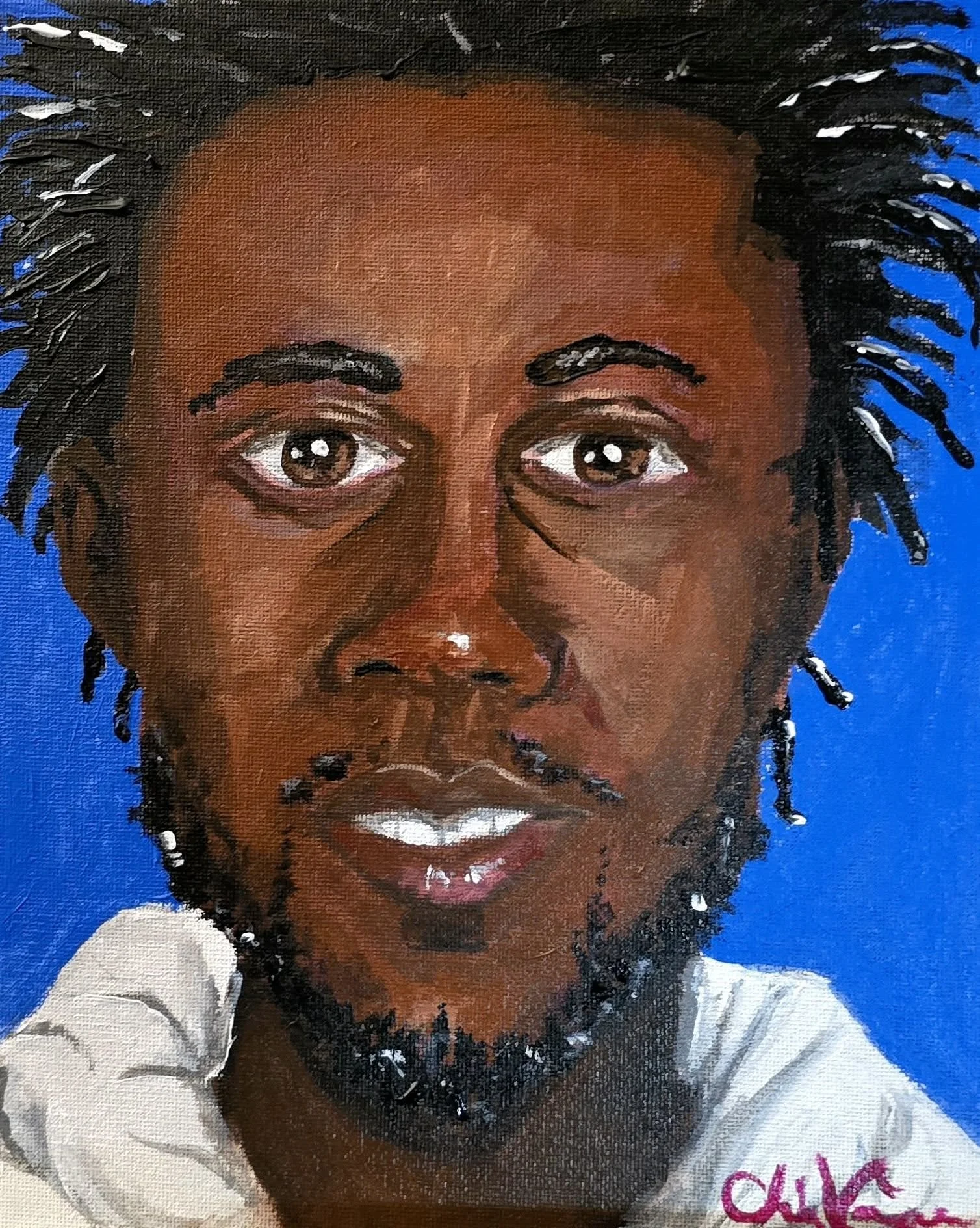 Close-up of a person's face with brown skin, dark eyes, and dreadlocks, wearing a white shirt, set against a blue background.