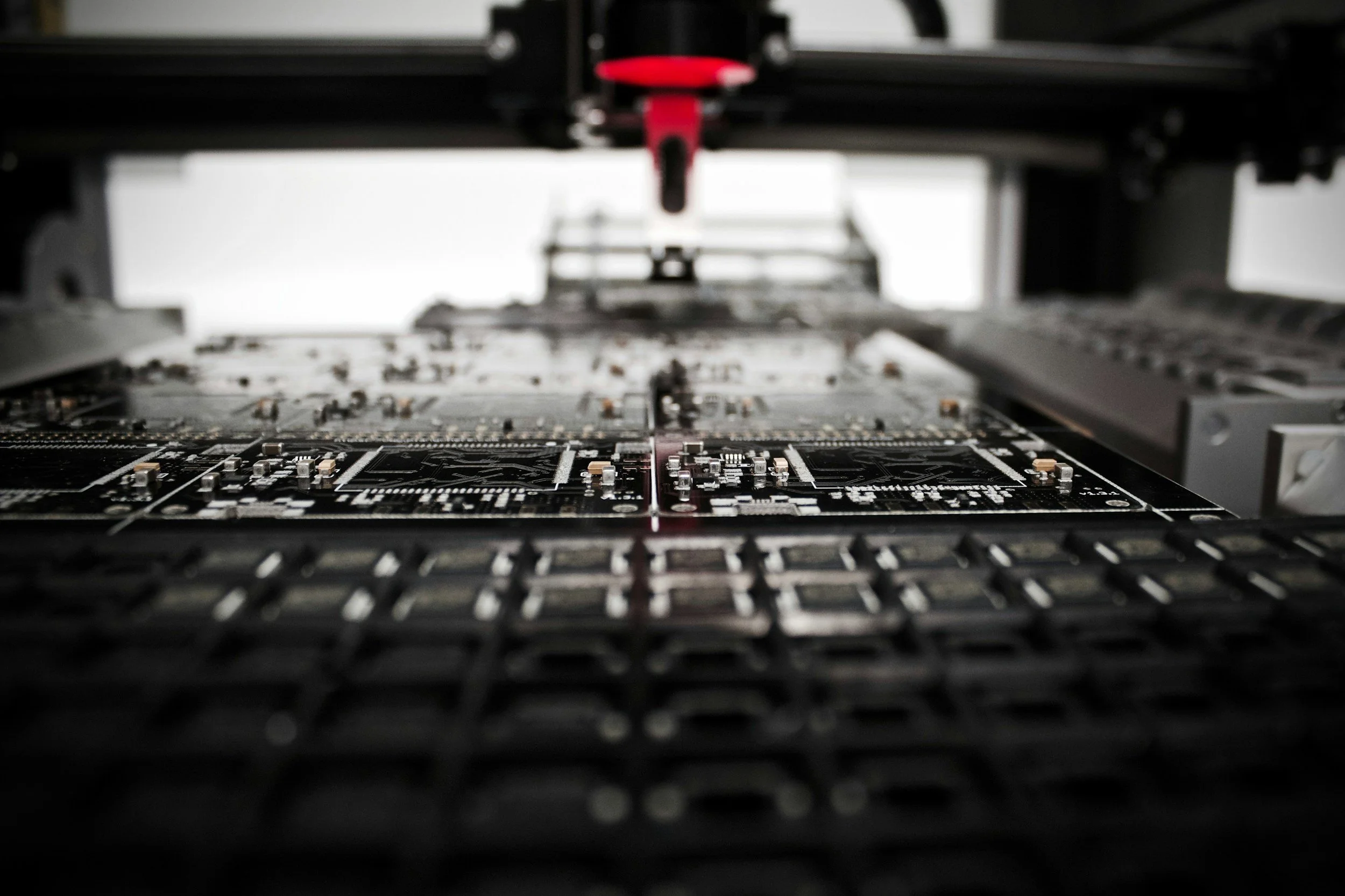 Close-up of a computer motherboard inside a 3D printer or CNC machine, with focus on the circuit board and mechanical parts surrounding it.