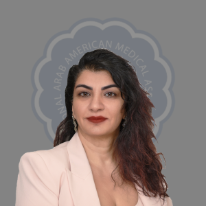 Portrait of a woman with dark wavy hair wearing a light blazer and red lipstick, against a gray background with a logo that reads 'Arab American Medical Alliance'.