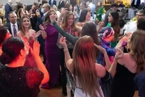 Group of young people dancing and socializing at a party or celebration.