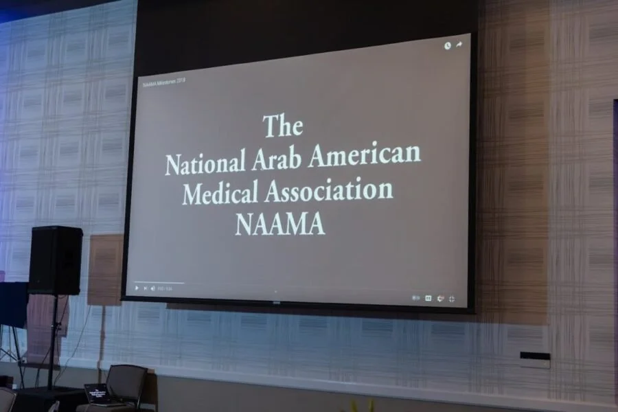 Projection screen displays the text: "The National Arab American Medical Association NAAMA."