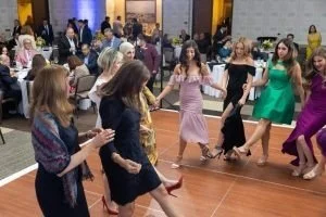 Group of women dancing in a social gathering or party.