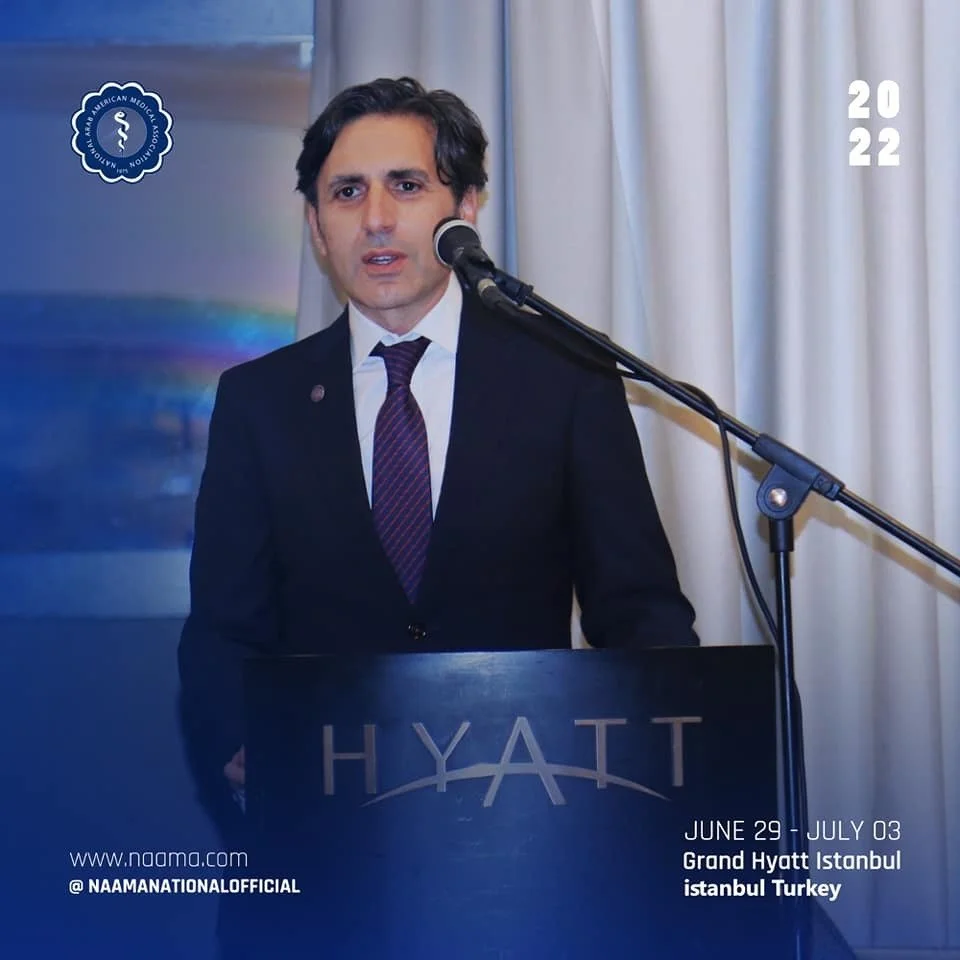 A man speaking at a podium with a microphone at a conference or event at the Grand Hyatt Istanbul in Turkey. The podium displays the Hyatt logo, and there are curtains behind him. The image indicates the event dates June 29 to July 3, 2022, and inclu