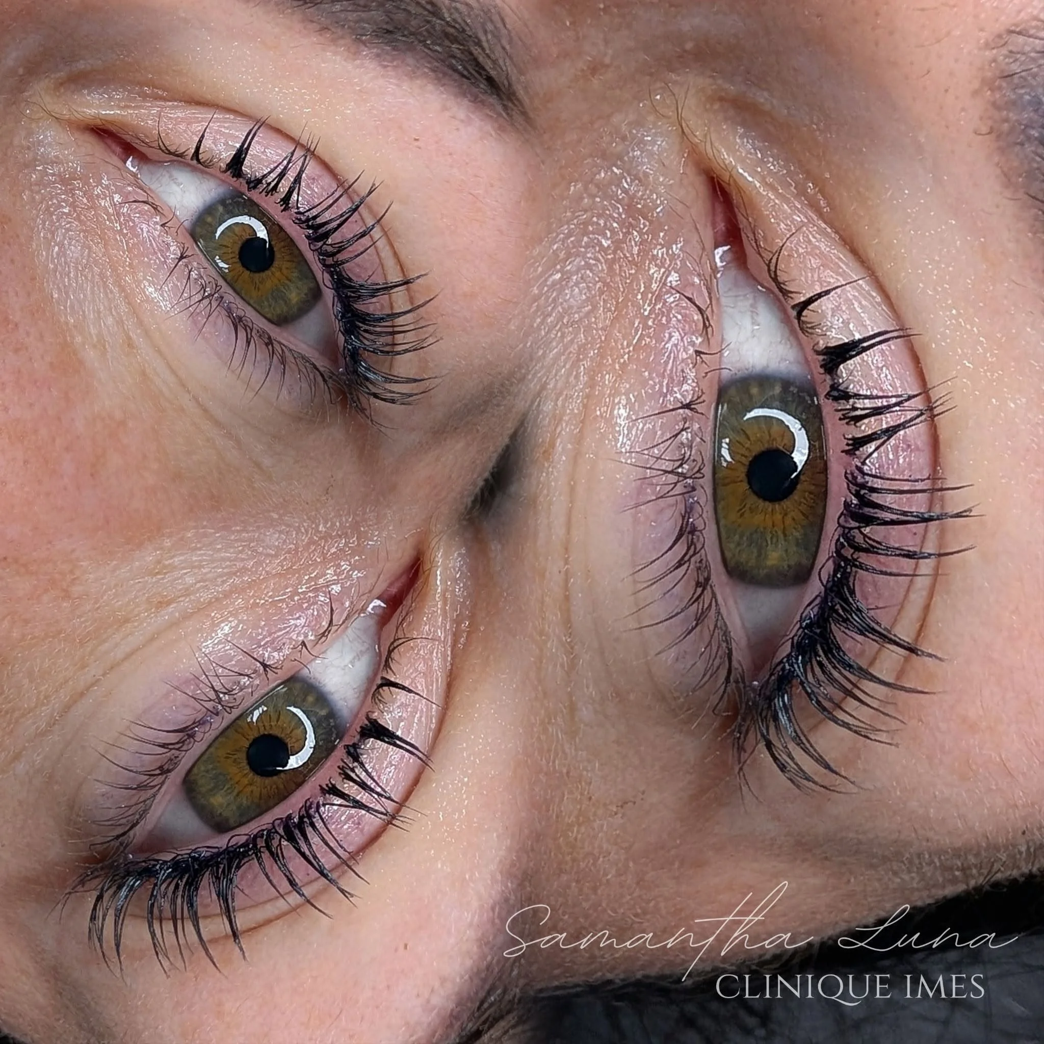 Close-up of a person's eye with brown iris, long eyelashes, and well-groomed eyebrows. The skin around the eye appears smooth and slightly shiny.