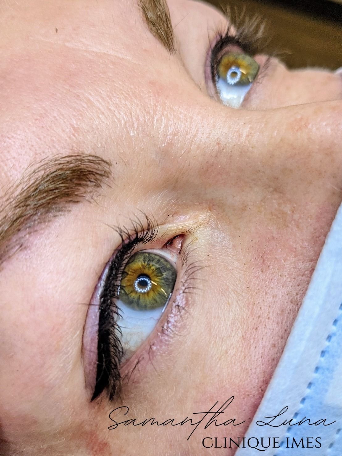 Close-up of a woman's face showing her eyes with makeup, gold eyeshadow, and long eyelashes, with the name "Samantha Luna" and the words "Clinique IMES" written on the bottom.